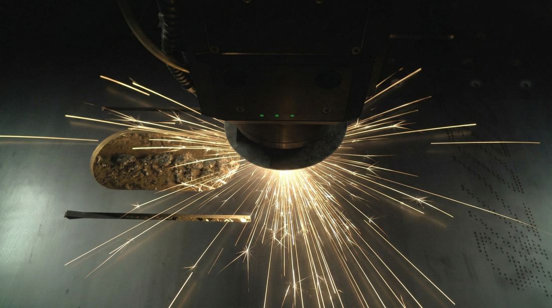 Laser cutting head cutting sheet metal, top-down view